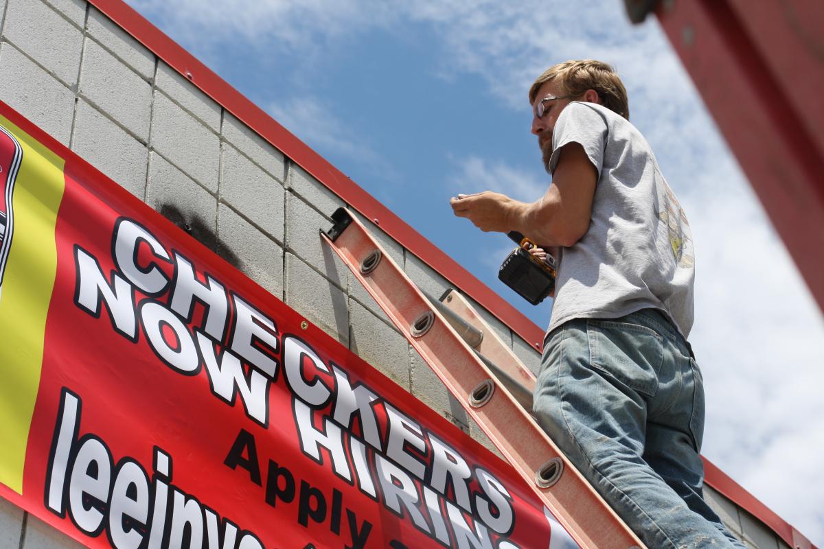 Christopher hanging the official sign